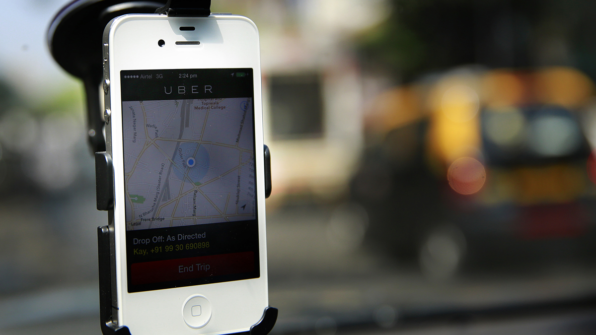  A smartphone is mounted on the glass of an Uber car.  Two judges ruled that Uber, Lyft and other ride-share companies were illegally offering public transportation in private vehicles.  (AP Photo/Rafiq Maqbool) 