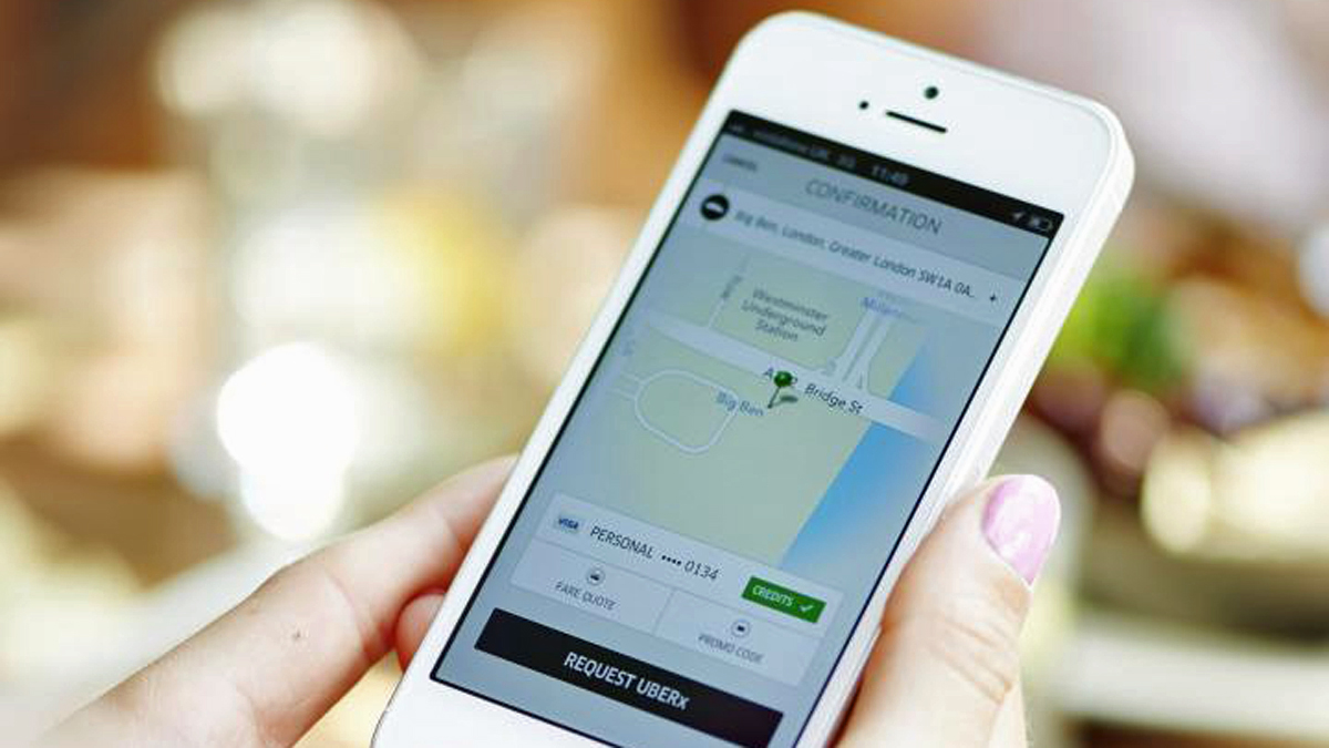  A model demonstrates how to use Uber's app to hail a ride. (Image courtesy of Uber) 