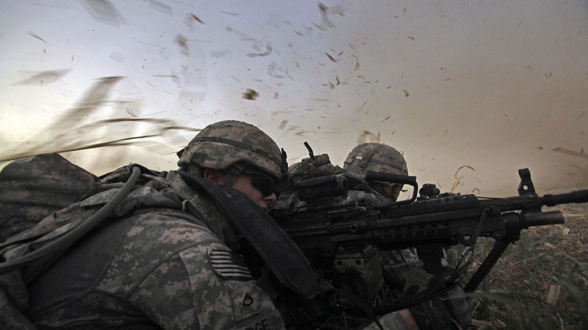  In this Monday, Aug. 8, 2011 photo, U.S. Army Pvt. 1st Class David Hedge from Bealeton, Va., front, and fellow soldiers from 1st Battalion, 18th Infantry Regiment  are bathed in rotor wash moments after arriving by Blackhawk helicopter for an operation to disrupt weapons smuggling in Istaqlal, north of Baghdad, Iraq. (AP Photo/Maya Alleruzzo) 