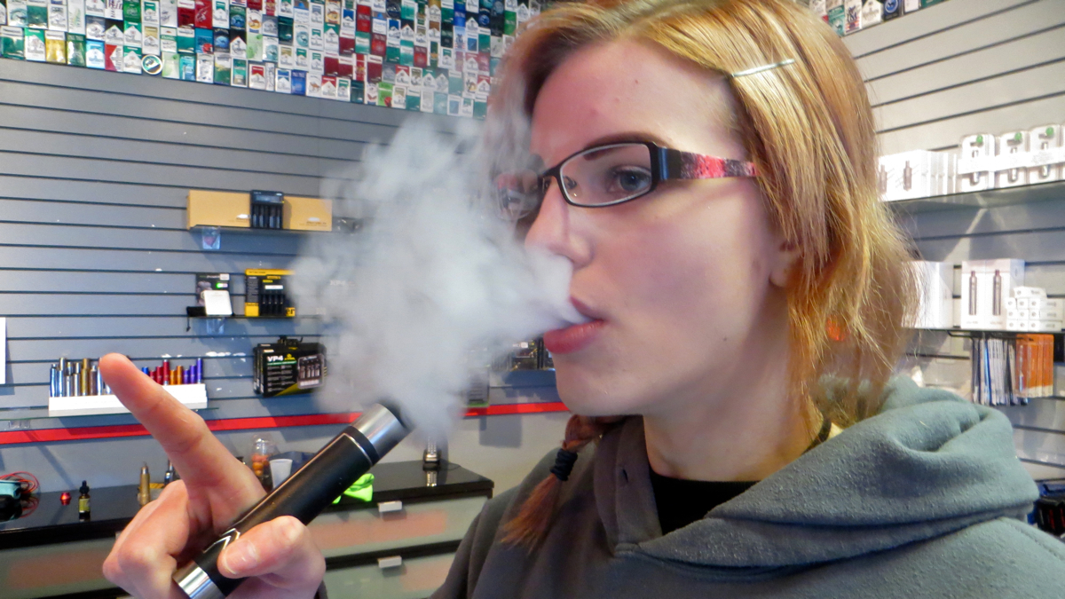  Delaware Vapor assistant manager Emily Skelton, 20, says she started smoking combustible cigarettes at age 12. Now she's been vaping for a year. (Taunya English/WHYY) 