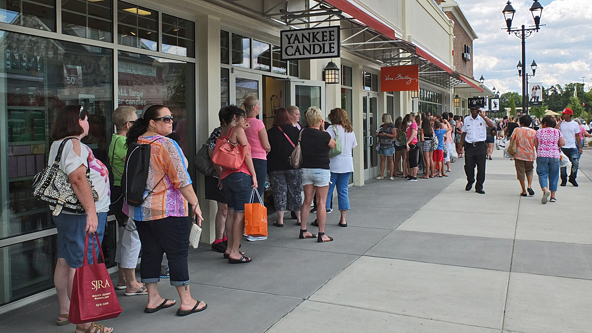  Shoppers were being let in these two stores on a one-to-one ratio as customers left. Most stores were not this busy. (Alan Tu/WHYY) 