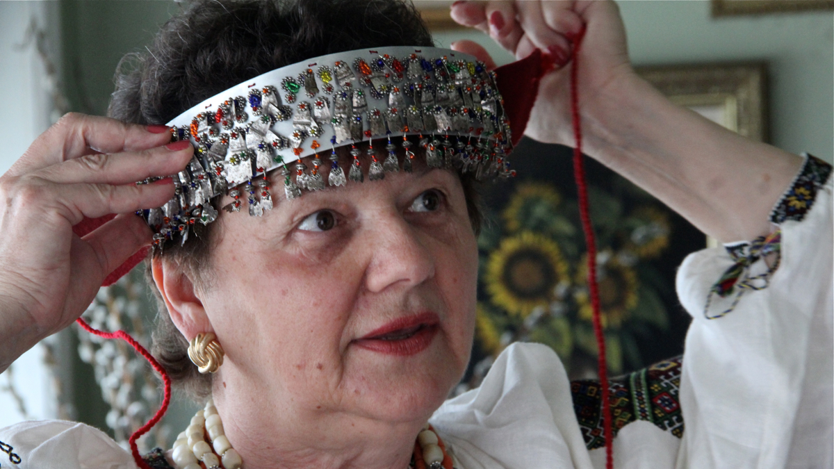Needlework artist Vera Nakonechny holds up a headband for a Ukrainian bridal headpiece. (Emma Lee/WHYY)