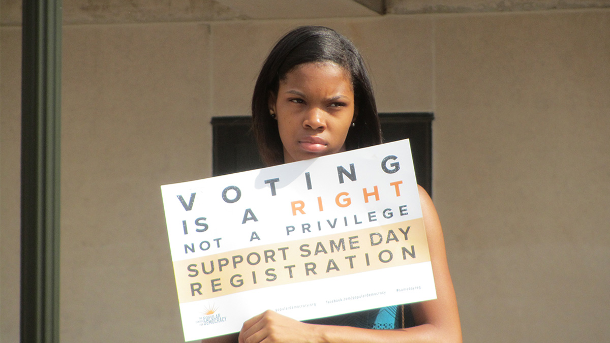 A supporter for same day voting registration at rally in Wilmington. (John Mussoni/WHYY) 