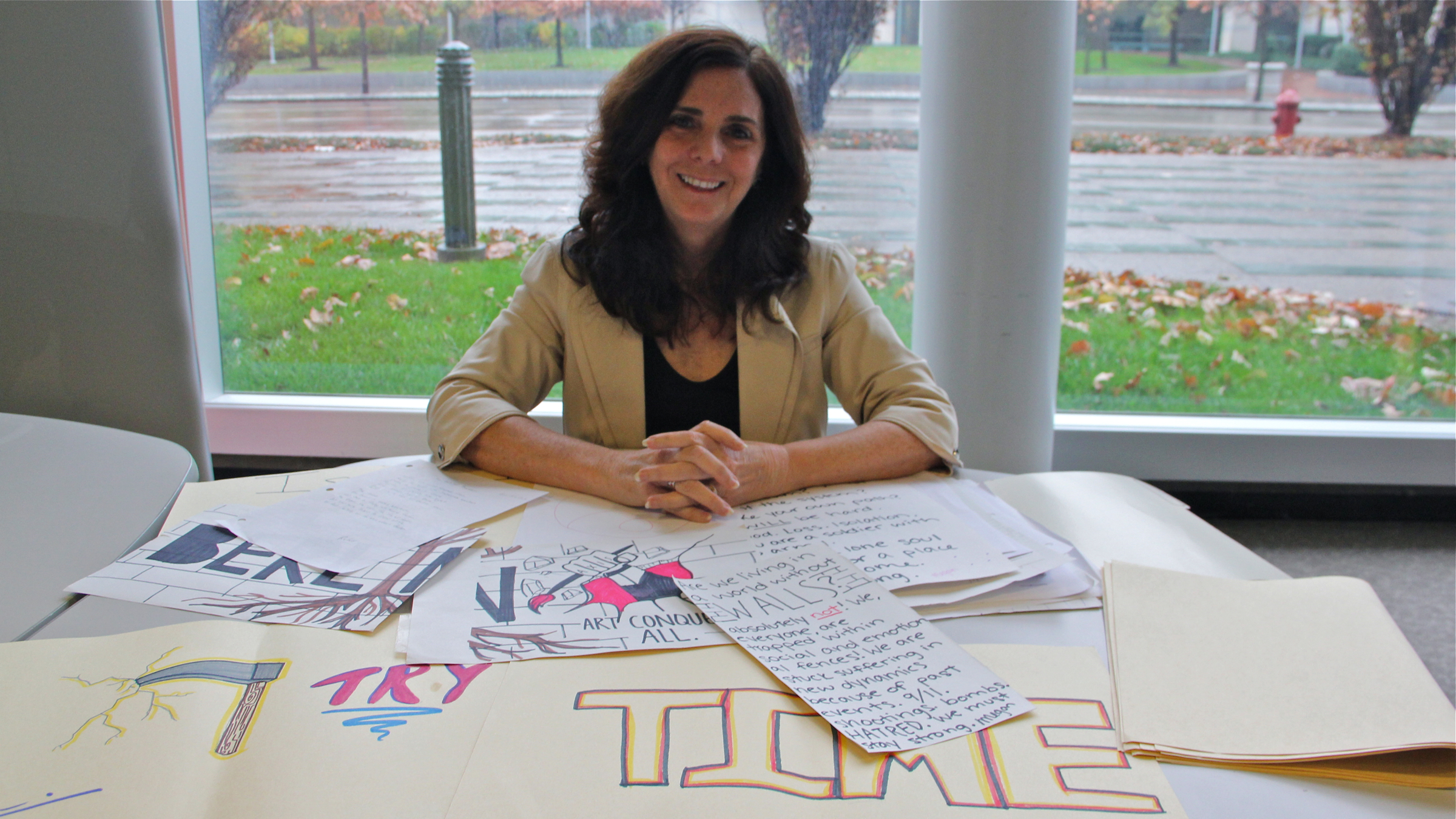  Beth Kephart displays work by students she met while visiting local high schools to discuss her new book, 'Going Over' (Emma Lee/WHYY) 