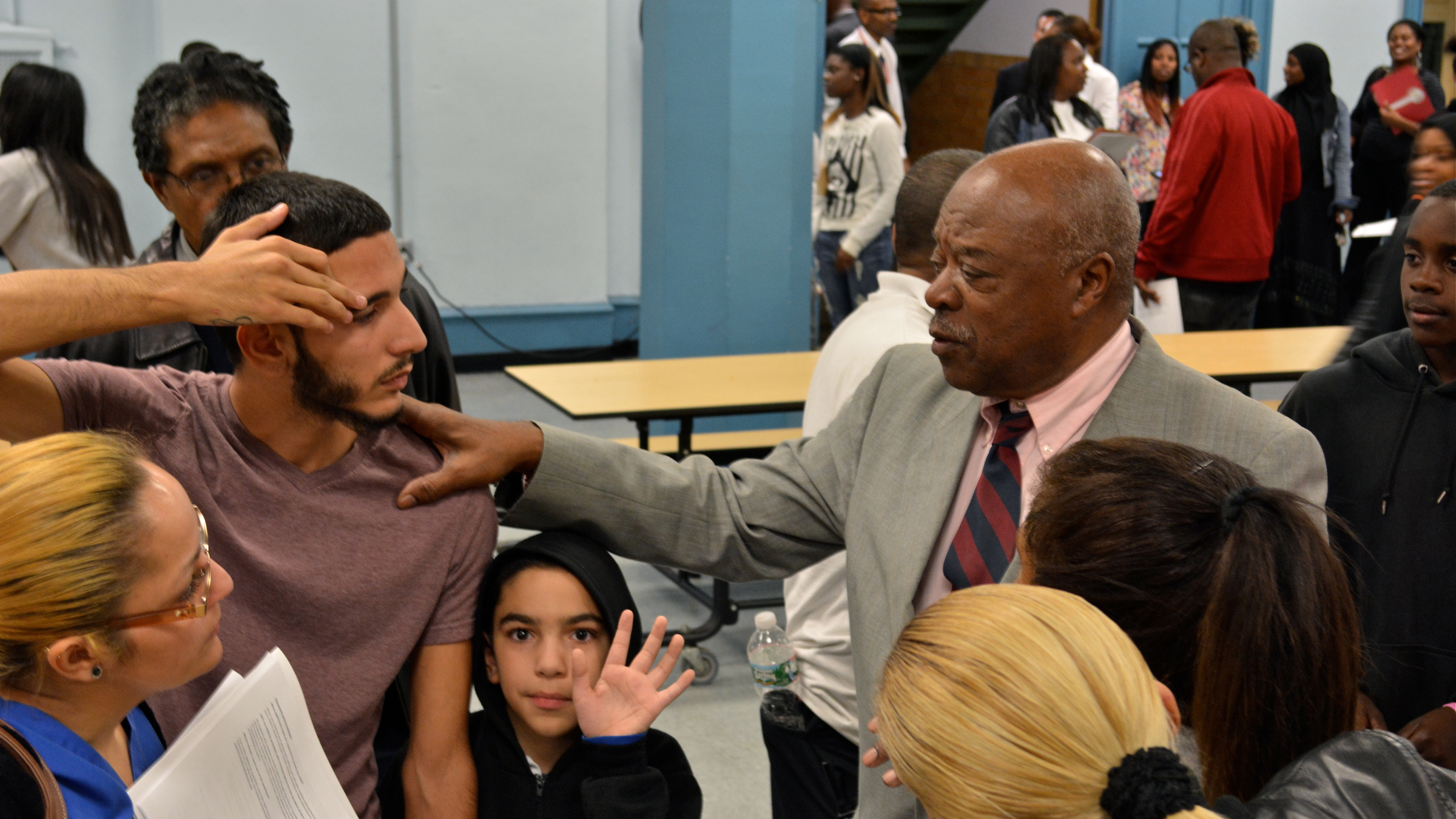  Walter Palmer (right) consoles a student who suddenly finds himself without a school. The embattled Walter D. Palmer Leadership Learning Partners Charter closed its high school and halved its elementary enrollment two months into the school year. (Kevin McCorry/WHYY) 