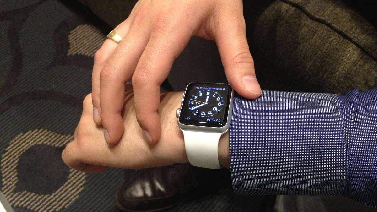 Sunkwon Bush sets up his new Apple Watch after its arrival last Friday at the Center City Philadelphia offices of Think Brownstone. (Carolyn Beeler/WHYY)