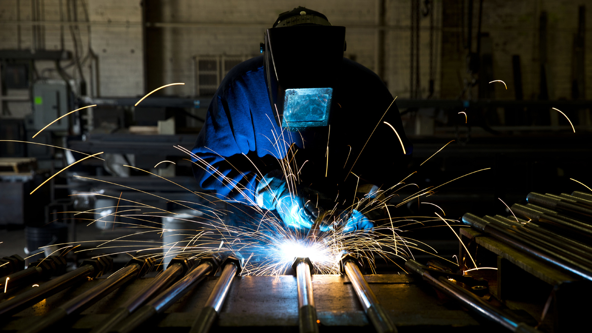 In this file photo, a welder fabricates anchor bolts for roads and bridges at the custom manufacturer in Pennsylvania.  (AP Photo/Matt Rourke) 