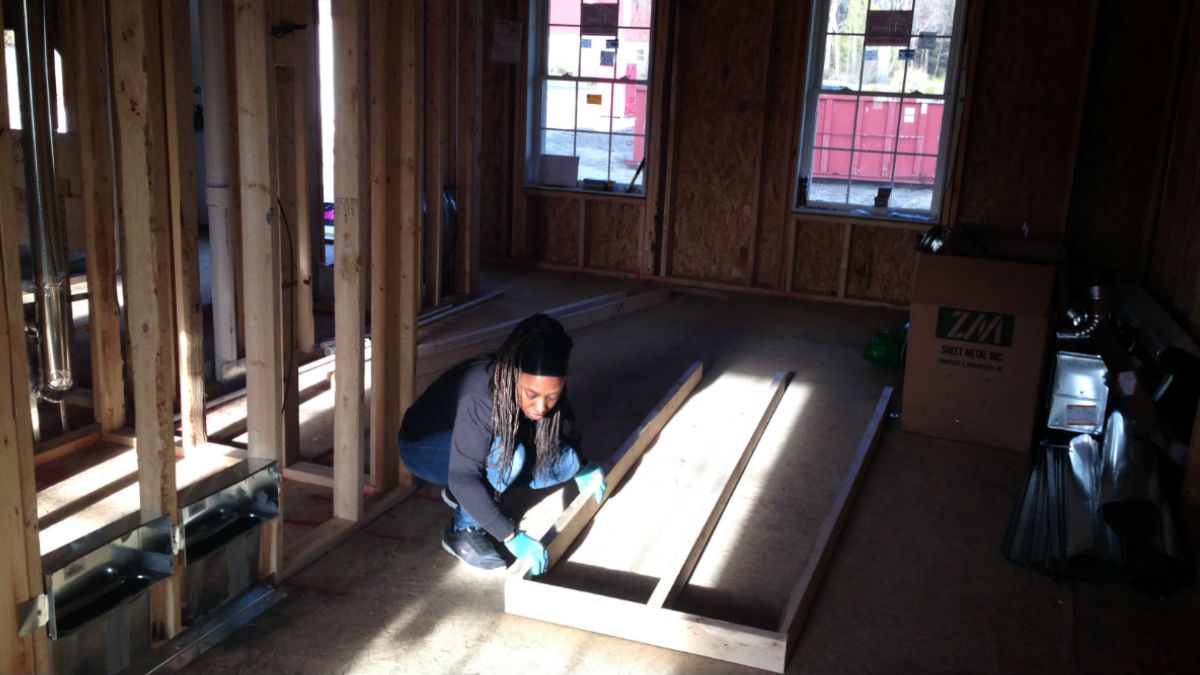  Amanda West works inside the home she's helping to build for her family in Georgetown. (Mark Eichmann/WHYY) 