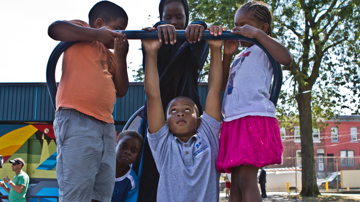 Kids at Wister Playground test out the new fitness equipment. (Kimberly Paynter/WHYY)