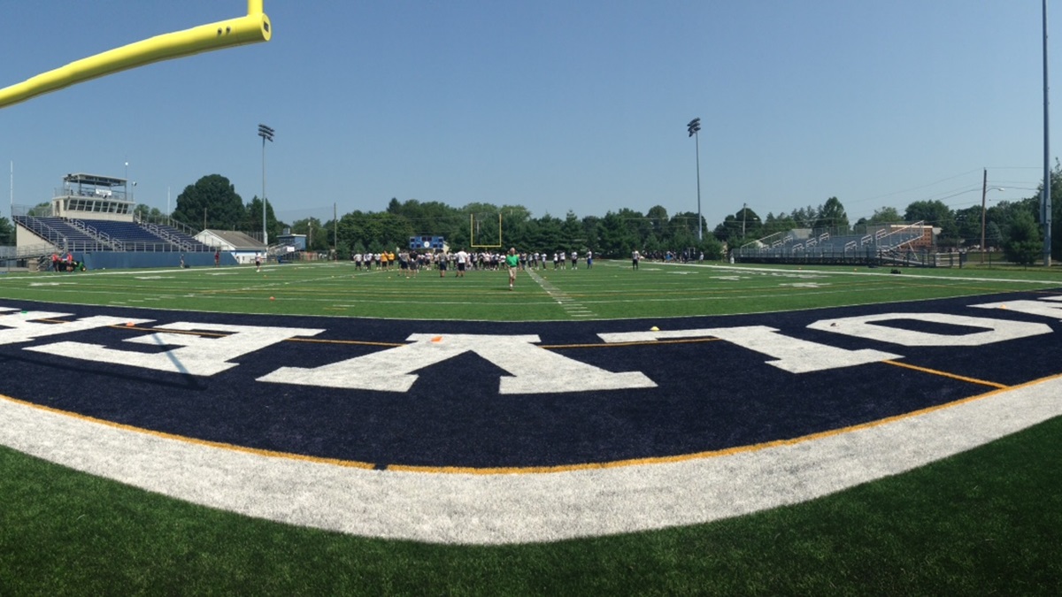  Wesley football players run through drills in Dover during a preseason practice. (Mark Eichmann/WHYY) 