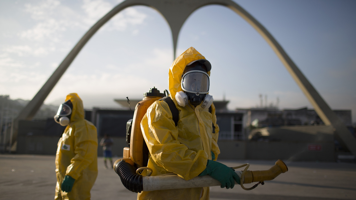 Health workers spray insecticide to combat the Aedes aegypti mosquito that transmits the Zika virus in Rio de Janeiro