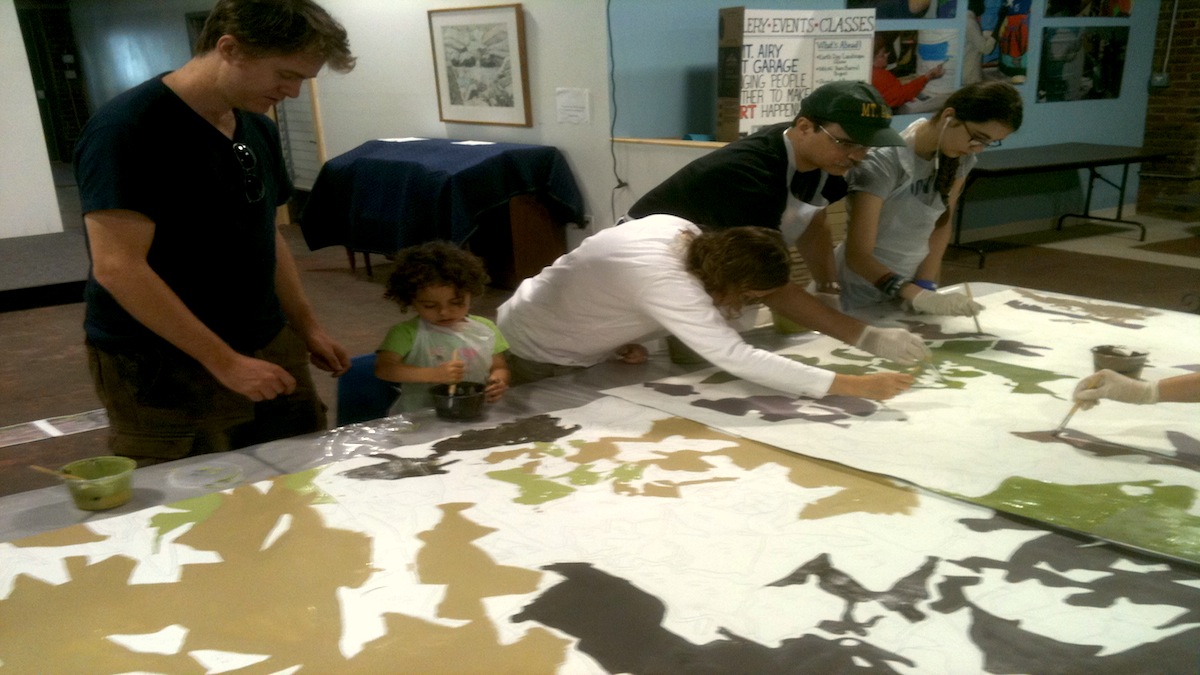  The Kleiner family works on a portion of the mural. (Karl Biemuller/for NewsWorks) 