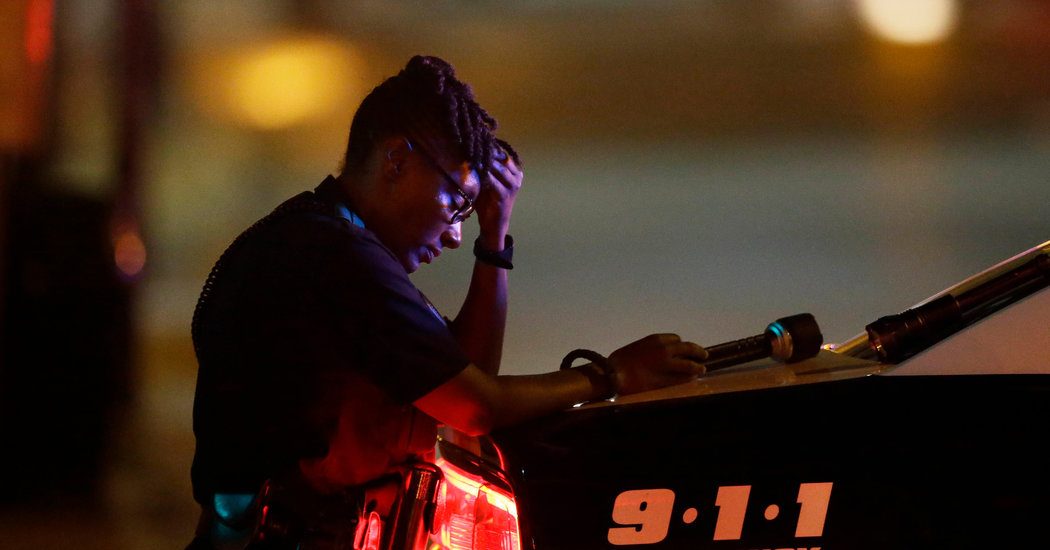  Black police officers, including this Dallas Police officer lamenting the deaths of her colleagues, live conflicted lives. (LM Otero/AP) 