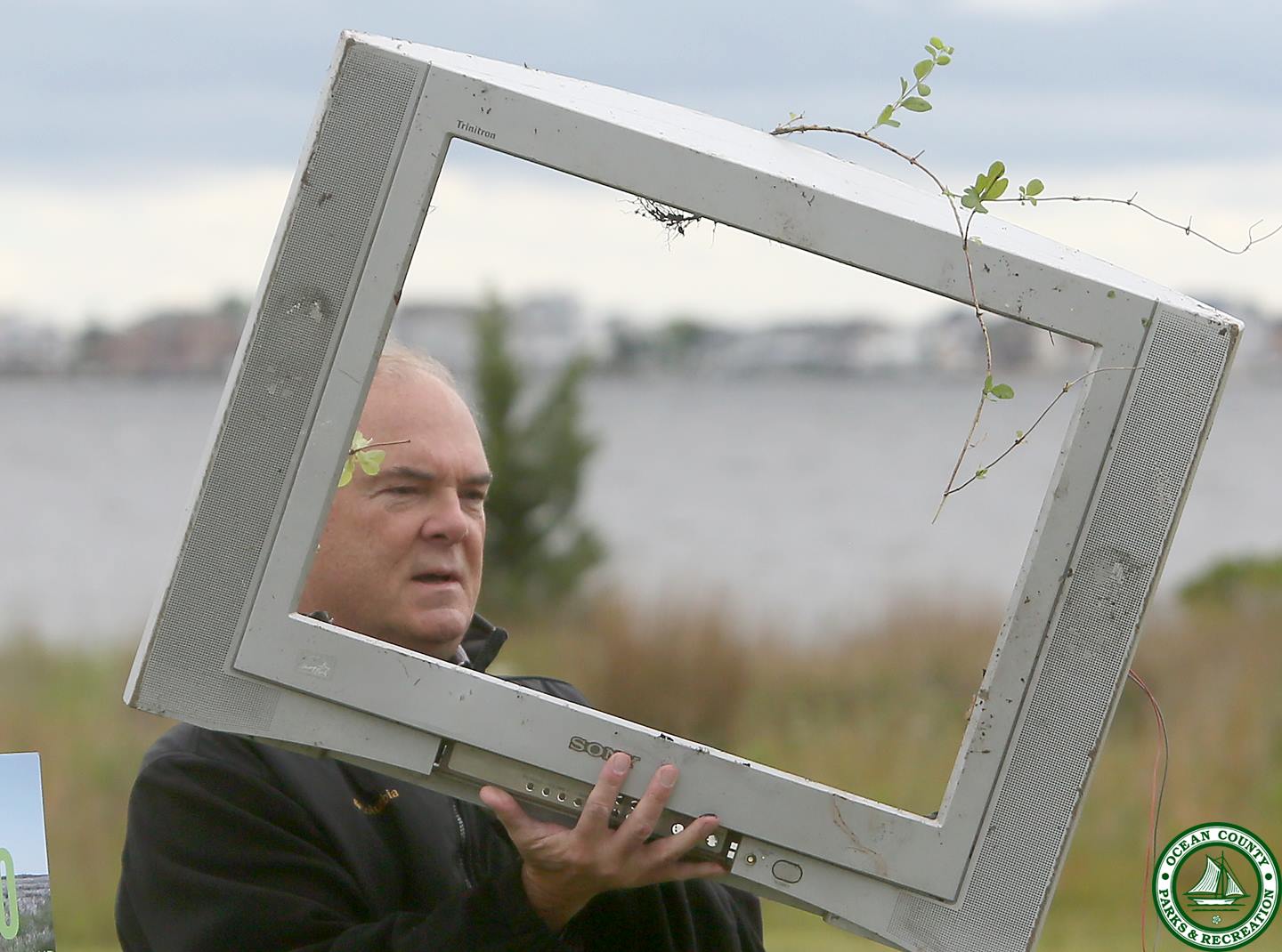  NJDEP Commissioner Bob Martin holds up an  example of trash removed from the Barnegat Bay watershed on the bayside lawn of the Ocean County Parks and Recreation administration offices in Toms River on Wednesday. (Image: Ocean County Parks and Recreation) 