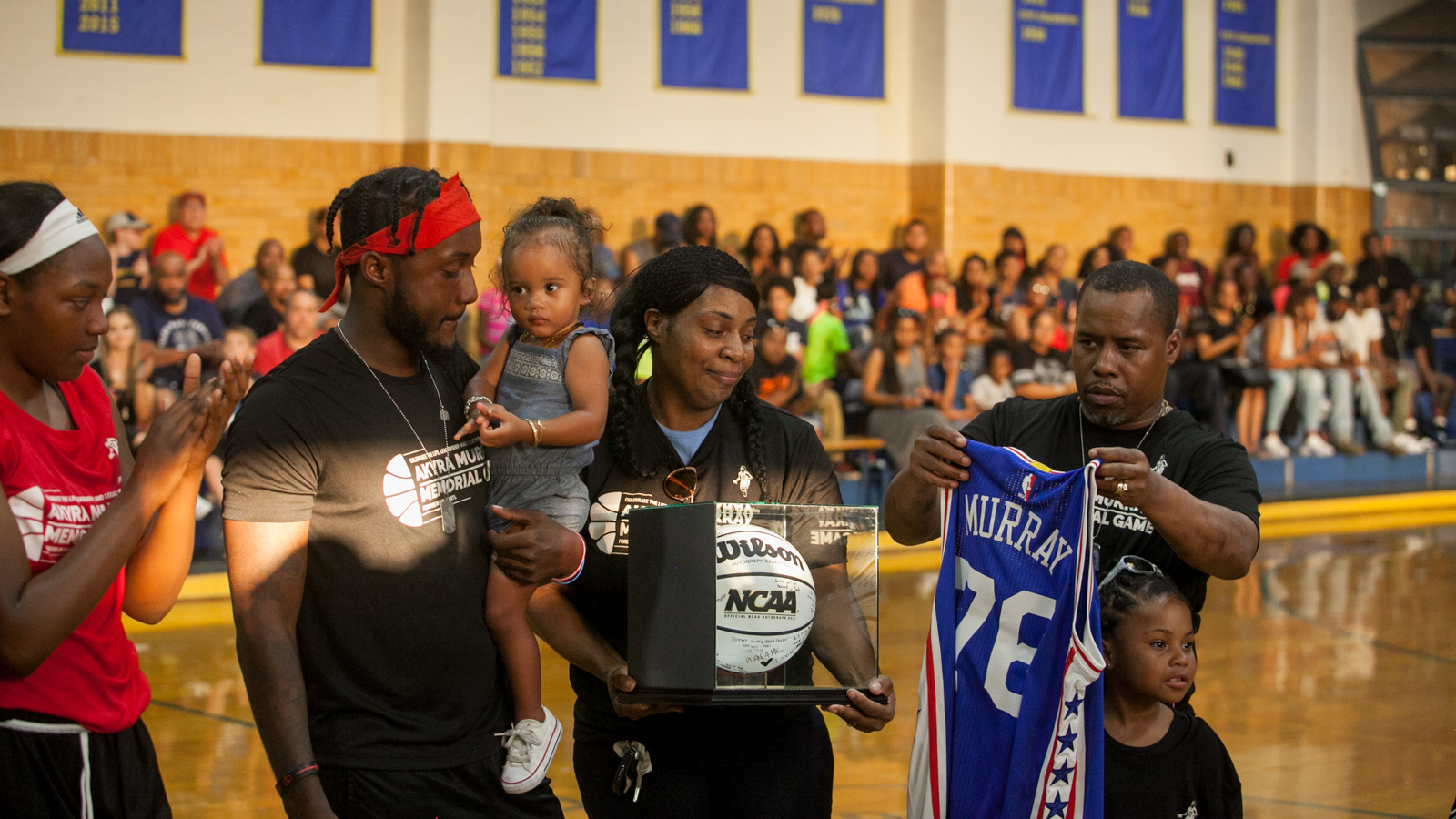 The family of Akyra Murray were honored at halftime during the memorial game for the slain West Catholic High basketball star who was kiled in the Pulse nightclub shooting in Orlando. (Brad Larrison for NewsWorks)