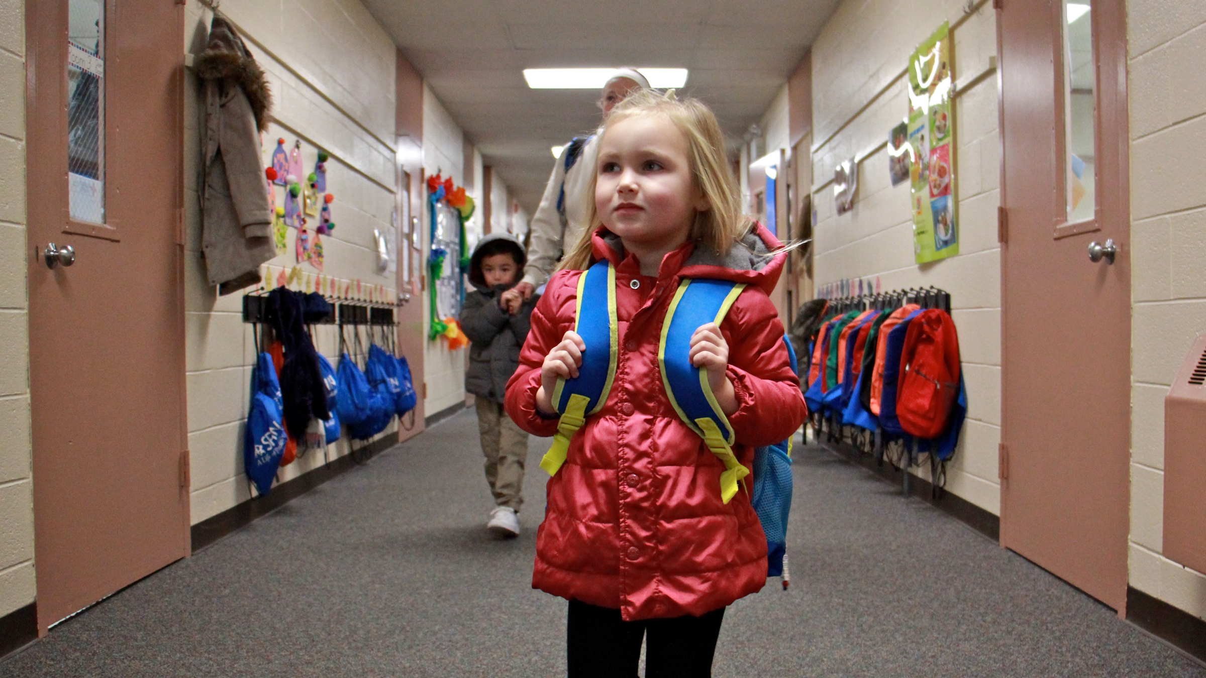 Aubrey Szafranski arrives for her first day of preschool at at SPIN-Parkwood in Northeast Philadelphia. Jan. 4, 2016 (Emma Lee/WHYY)