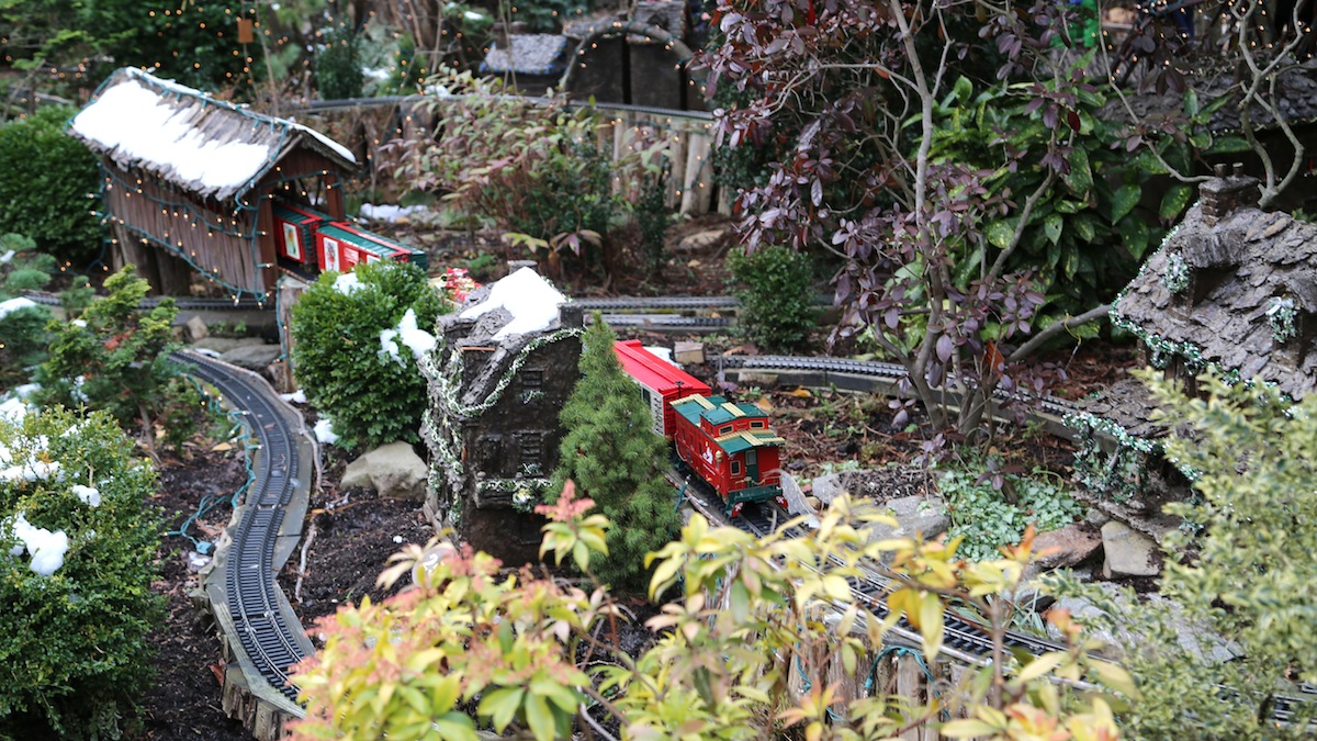 Model trains are running through a whimsical village of miniature historic buildings, tunnens and waterfalls (Natavan Werbock/for NewsWorks)