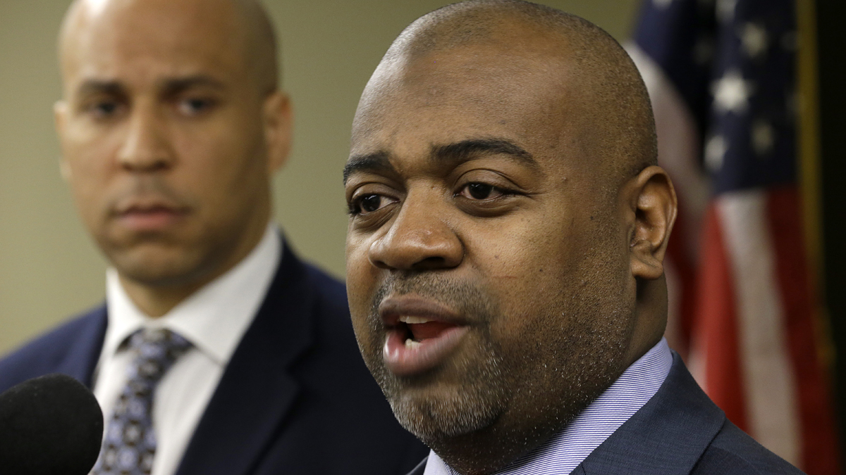  Newark Mayor Cory Booker, left, looks on as Newark Southward Councilman Ras Baraka talks during a news conference, Wednesday, March 27, 2013, in Newark, N.J. (AP Photo/Julio Cortez) 