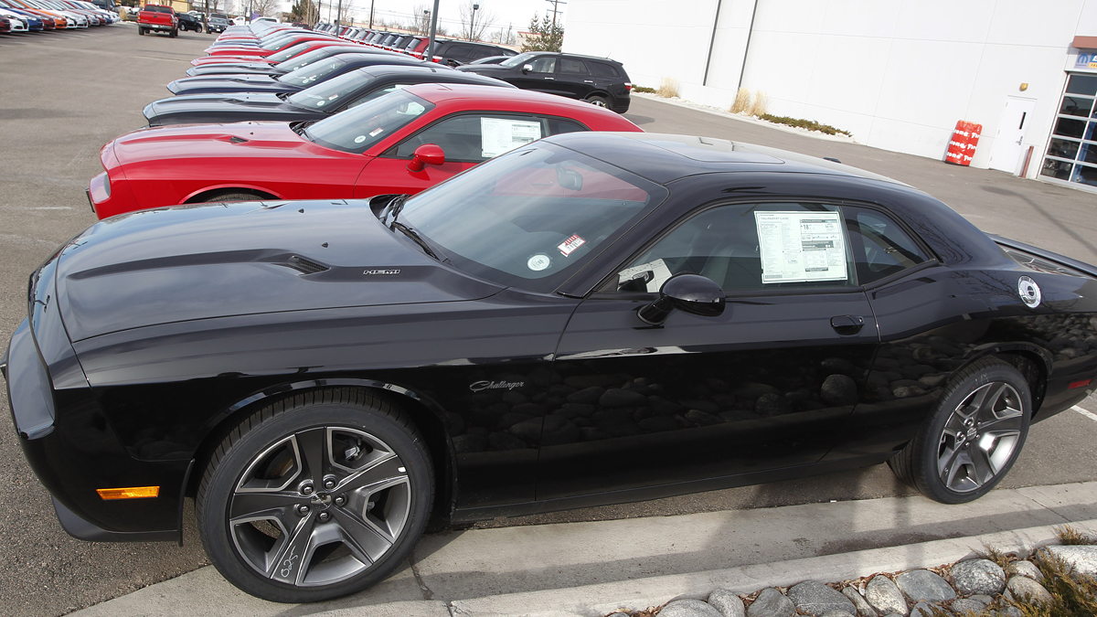 In this file photograph taken on Sunday, Jan. 20, 2013, a line of 2013 Challengers sits at at a Dodge dealership in Littleton, Colo. (AP Photo/David Zalubowski)