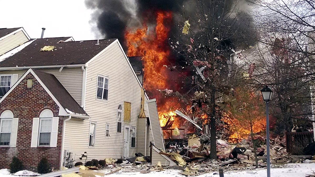  In this image provided by Josh Forst, flames and smoke shoot up after an explosion at a townhouse complex Tuesday.  (AP Photo/Josh Forst) 