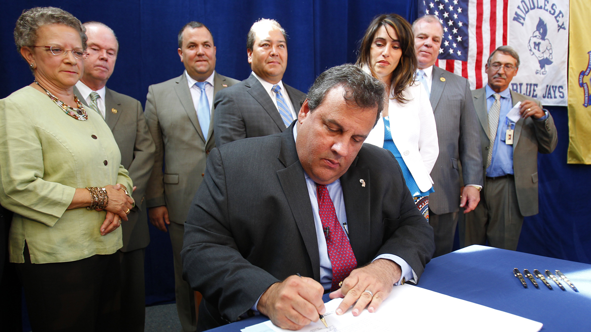  Gov. Christie signs the teacher tenure reform bill on Aug. 6, 2012.  (AP Photo/Rich Schultz) 