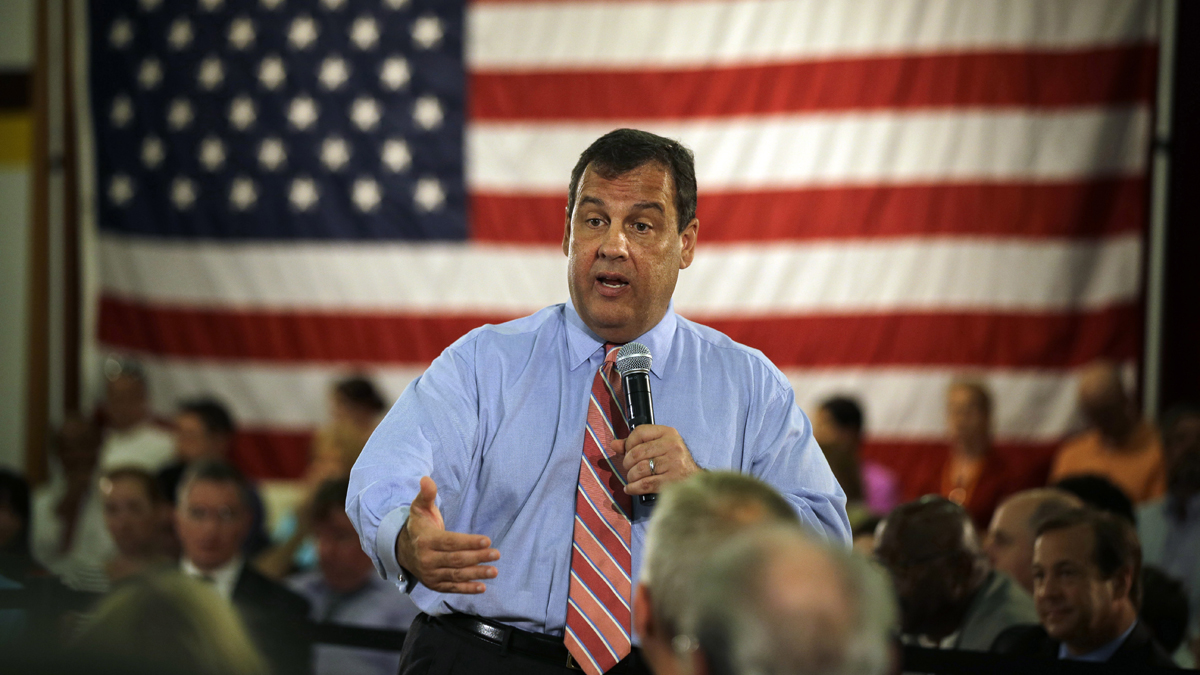  A large American flag is part of Christie's town hall setting,  Christie in Haddon Heights, NJ in 2014.  (AP Photo/Mel Evans) 