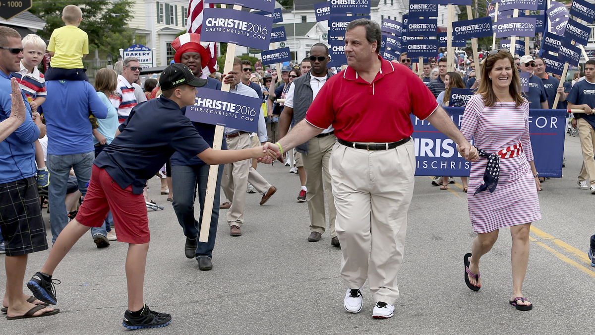  Chris Christie shakes hands with a supporter as he walks in a Fourth of July parade in Wolfeboro, N.H. (AP Photo/Mary Schwalm) 