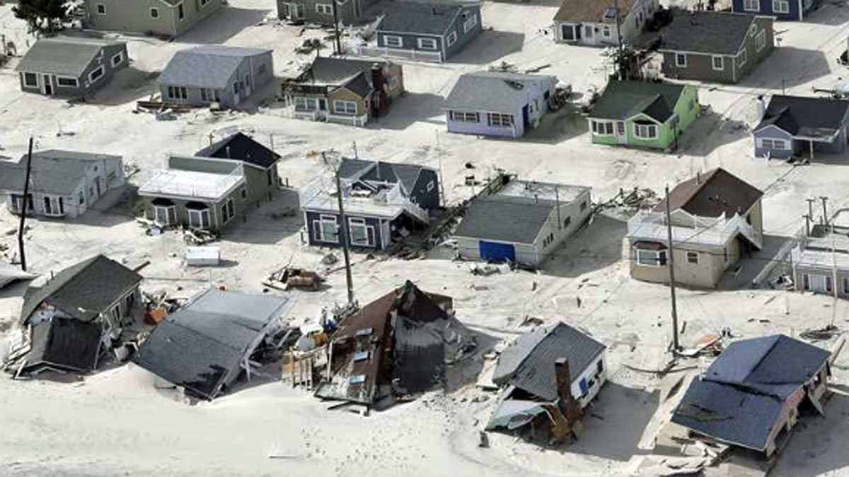 In this aerial photo, sand fills the streets in the wake of Superstorm Sandy, Wednesday, Oct. 31, 2012, along the Jersey Shore, N.J. (Mike Groll/AP Photo) 