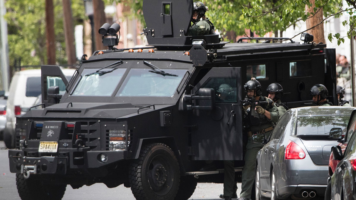  Police stand next to an armored vehicle during a standoff with a man in a home in Trenton, N.J., on Wednesday, May 10, 2017. Police said they are trying to negotiate with the suspect after a fatal gunfire exchange with police. (AP Photo/Matt Rourke) 
