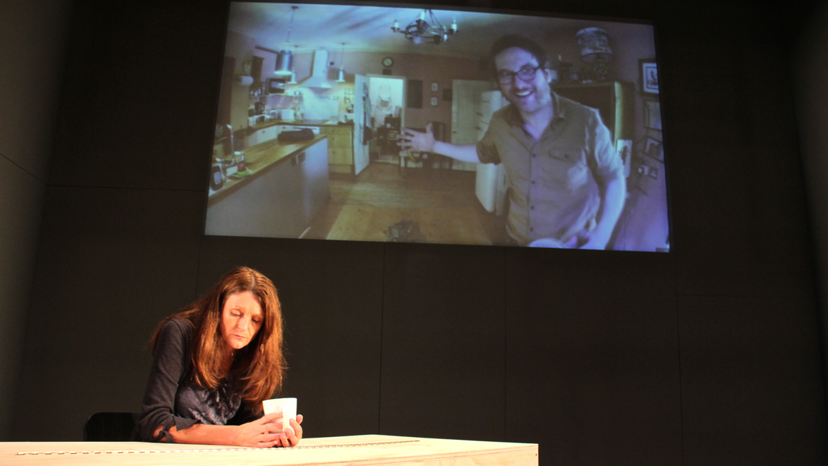  In ''Perfect Blue,'' performed simultaneously in London and Philadelphia, Carys (Emma Gibson) and her husband, Michael (Harry Smith), lose their marriage in the midst of a global crisis while attempting to communicate by video chat. (Emma Lee/WHYY) 