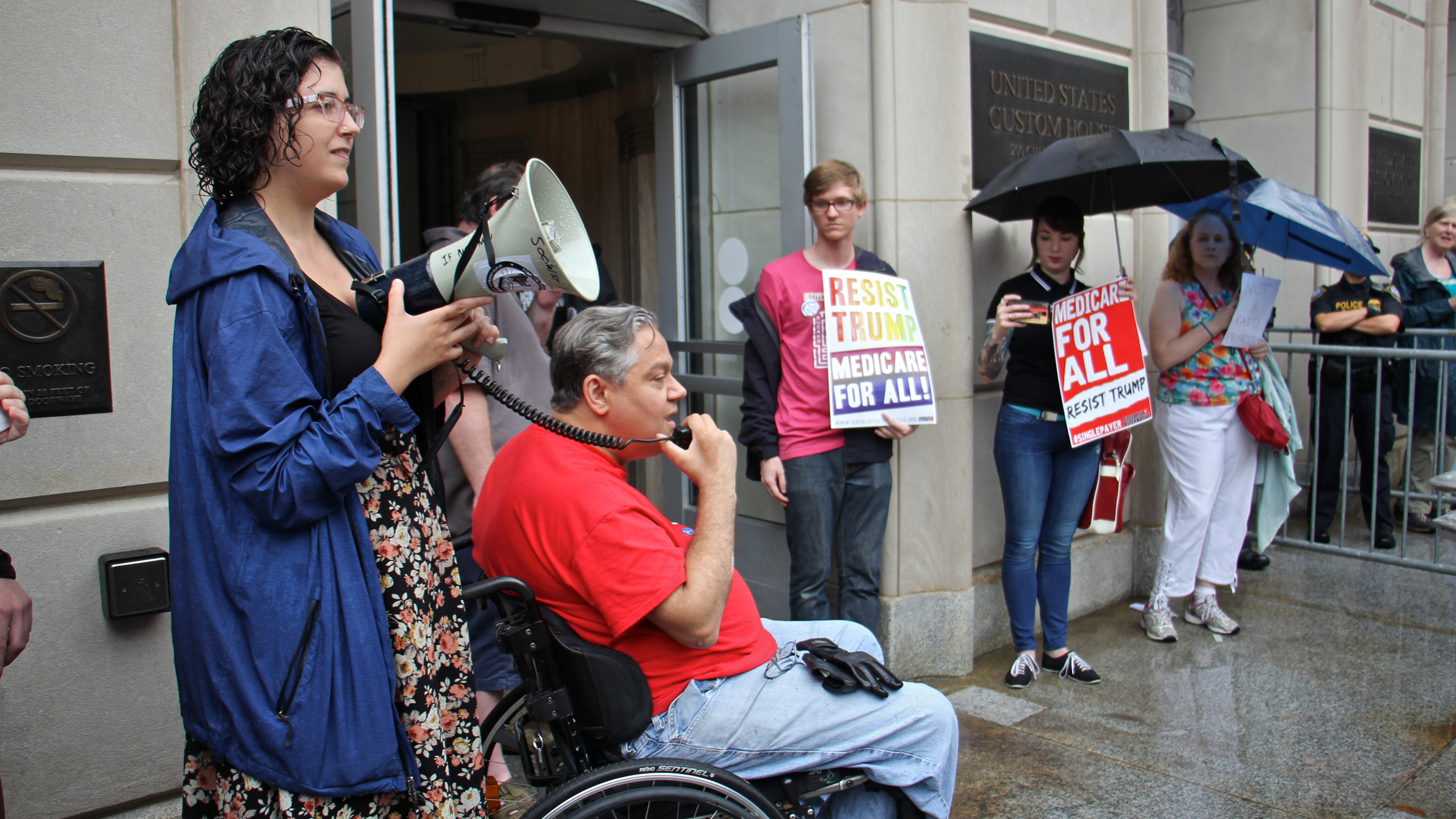  Protesters gather at the entrance to the United States Custom House, where U.S. Sen. Pat Toomey has his Philadelphia office. (Emma Lee/WHYY) 