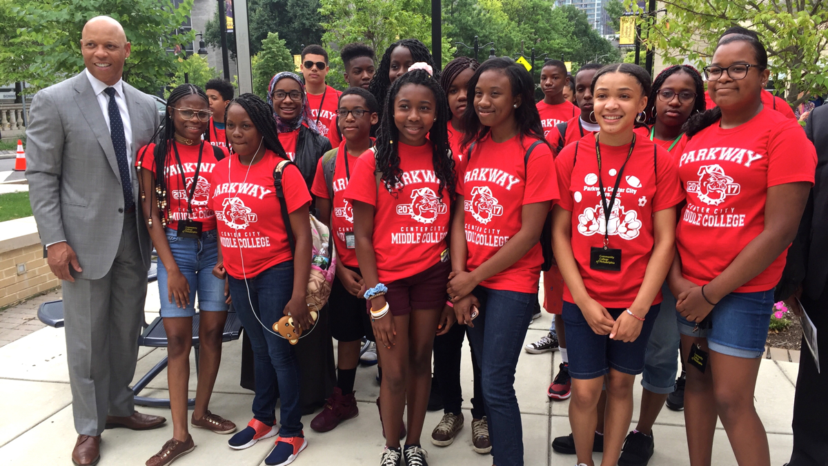Students from the Parkway Center City Middle College high school pose with Philadelphia schools Superintendent William Hite during a program at the Community College of Philadelphia that allows students to earn college credits while still in high school. (Avi Wolfman-Arent/WHYY) 