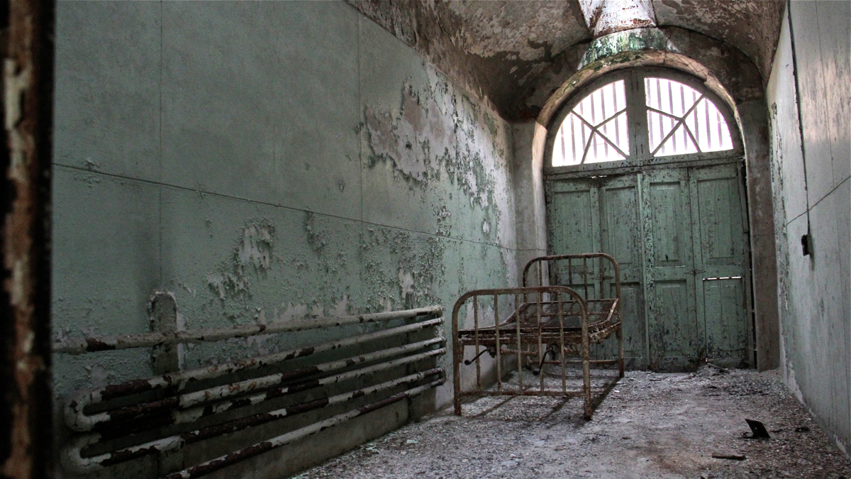 Cells for tuburculosis patients included wooden folding doors backed by iron bars so inmates could take the air. About half of all deaths at the prison were attributed to tuberculosis. (Emma Lee/WHYY)