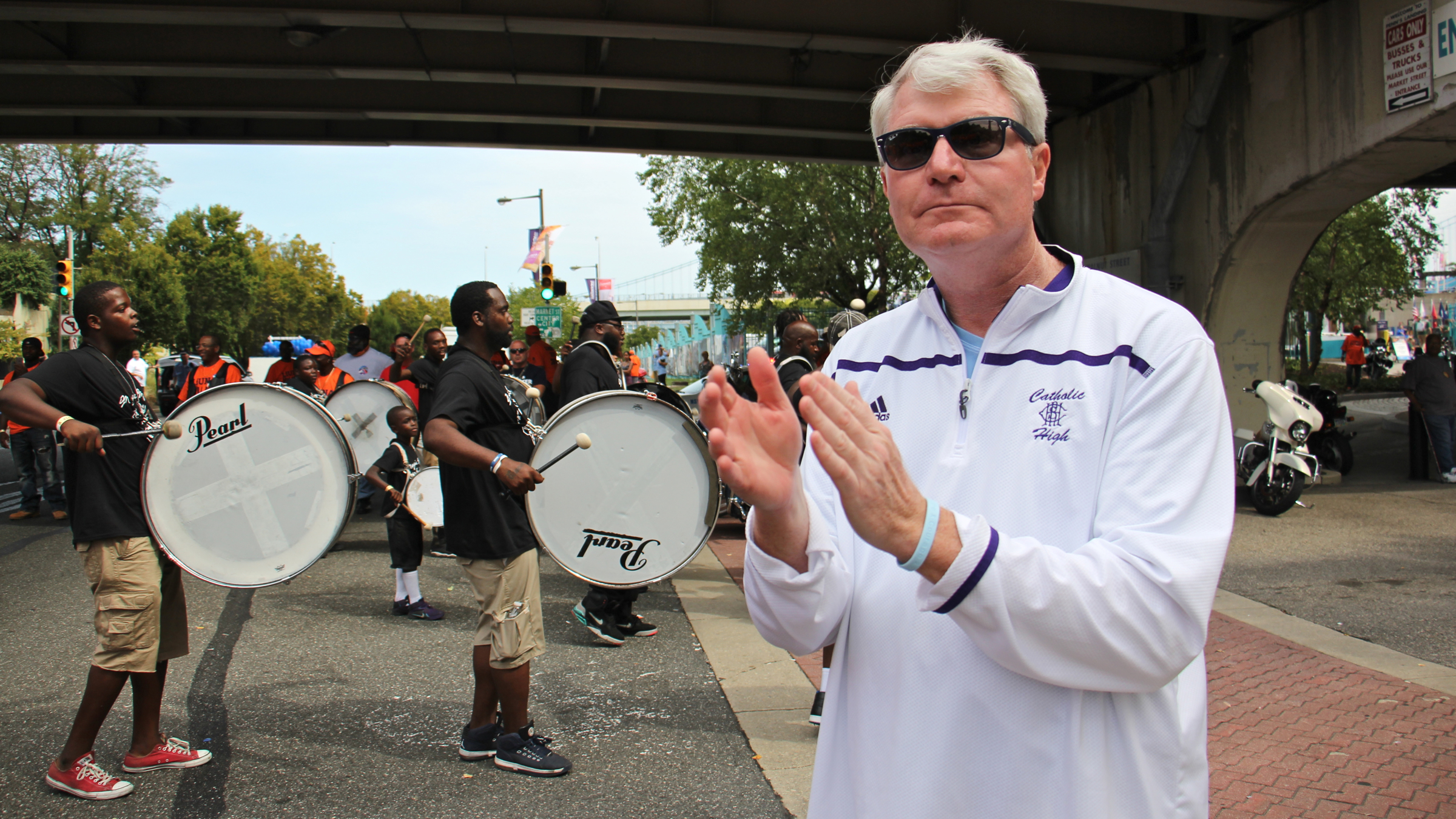 Labor leader Johnny Dougherty applauds marchers in the Labor Day parade on Columbus Boulevard. Dougherty and his union