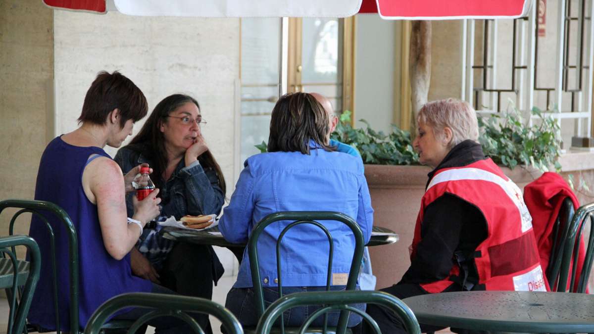 A Red Cross volunteer talks with survivors at 30th Street Station