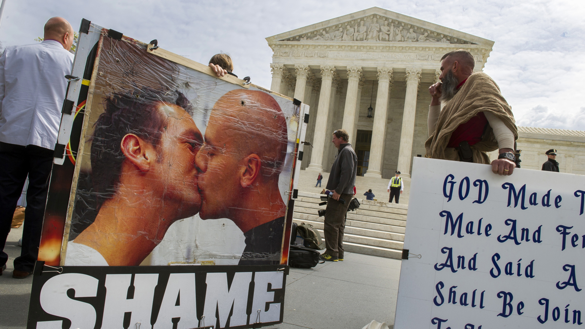  Anti-gay marriage protestors demonstrate in front of the Supreme Court in Washington, Monday, April 27, 2015. The opponents of same-sex marriage are urging the court to resist embracing what they see as a radical change in society's view of what constitutes marriage. (AP Photo/Cliff Owen) 
