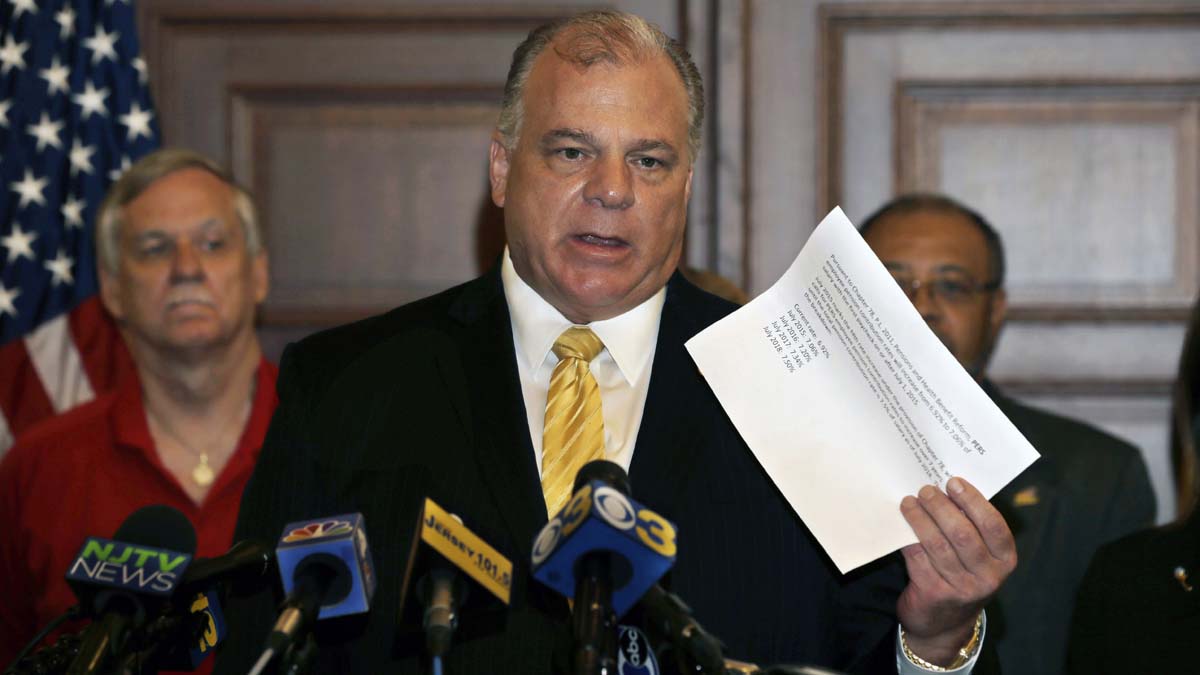  New Jersey Senate President Steve Sweeney holds up a paper that shows planned increases in the amount that public workers must contribute to their pensions under a previous agreement with the Christie administration. Earlier Tuesday, the New Jersey Supreme Court sided with Gov. Chris Christie in a fight with public worker unions over pension funds. New Jersey's top court overturned a lower-court judge's order that told the Republican governor and the Democrat-controlled Legislature to work out a way to increase pension contributions for the current fiscal year. (AP Photo/Mel Evans) 