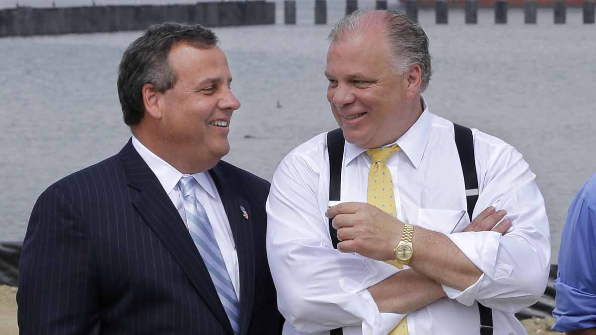 In this file photo, New Jersey Gov. Chris Christie, (left), shares a laugh with Senate President Steve Sweeney during a July event in Paulsboro.  (AP, file) 