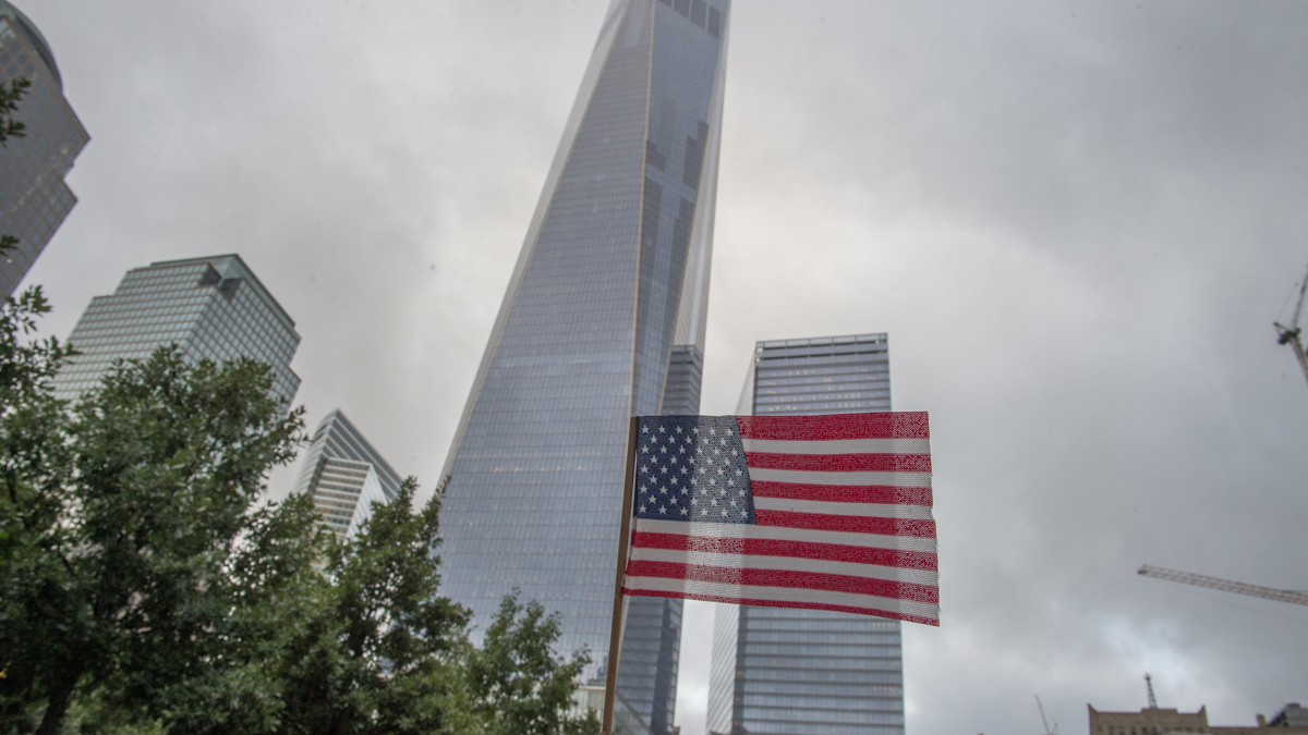 A flag is placed along the South Pool prior to a ceremony at the World Trade Center site in New York on Friday, Sept. 11, 2015. With a moment of silence and somber reading of names, victims' relatives began marking the 14th anniversary of Sept. 11 in a subdued gathering Friday at ground zero. (AP Photo/Bryan R. Smith)