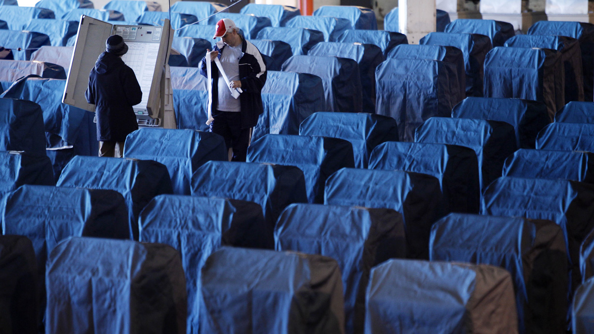 Technicians test voting machines in Philadelphia in 2010. The machines, now about a decade old, will not be replaced before the presidential primaries and general election this year. (AP file photo) 