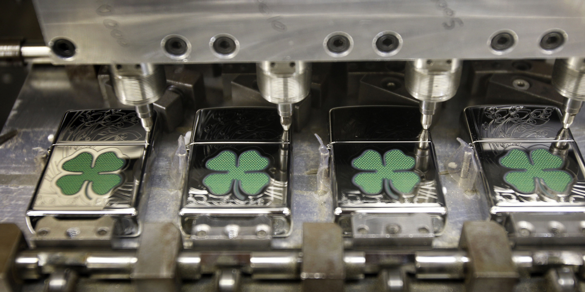  A pattern is etched onto the surface of Zippo lighters at the Zippo Manufacturing Co. factory in Bradford, Pennsylvania. The company has announced layoffs after missteps in the Chinese market. (AP file photo) 