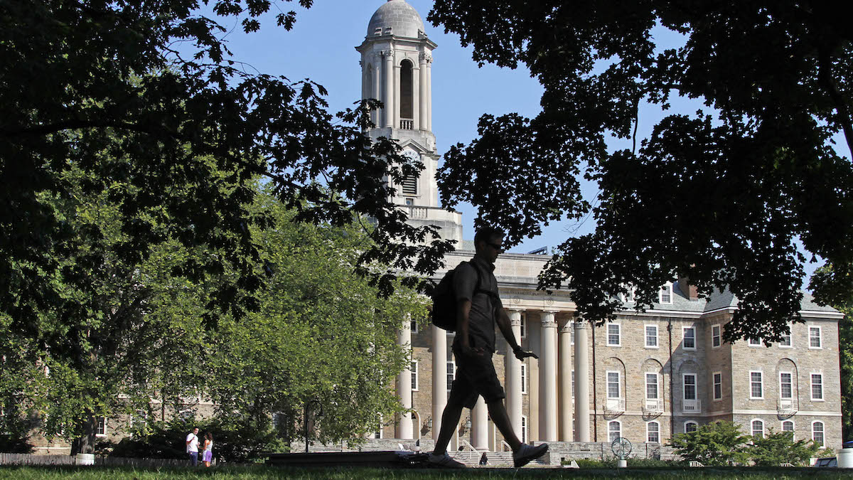 A Penn State University student walks across campus