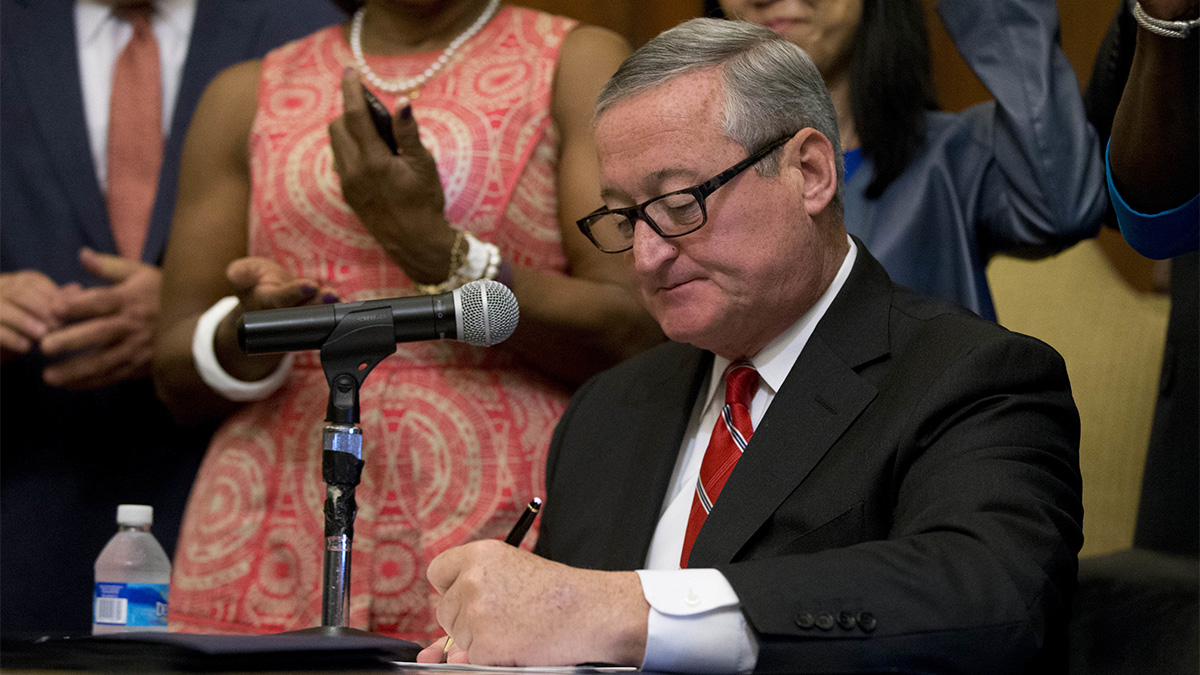 Mayor Jim Kenney signs into law a 1.5 cents-per-ounce tax on sugary and diet beverages at City Hall in Philadelphia Monday. The tax will be levied on distributors and is set to take effect Jan. 1. (AP Photo/Matt Rourke)