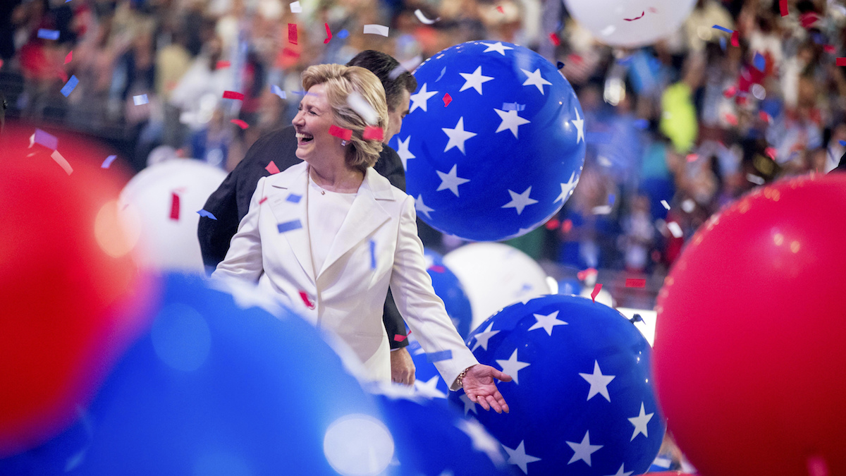Democratic presidential candidate Hillary Clinton reacts to confetti and balloons as she stands on stage during the final day of the Democratic National Convention in Philadelphia