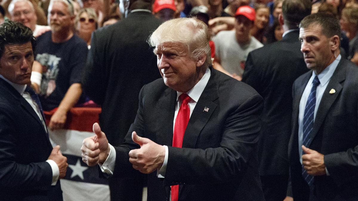 Republican presidential candidate Donald Trump gives a thumbs up as he leaves a campaign rally in Altoona