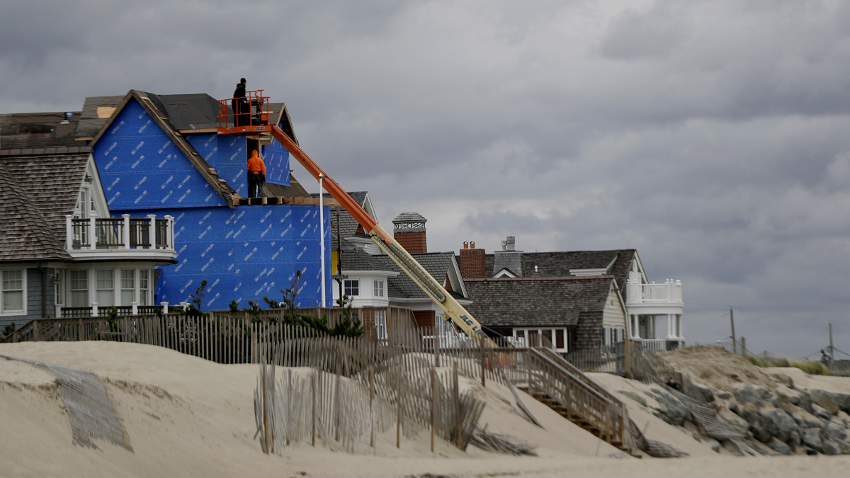 Construction workers labor on a beachfront home in Bay Head