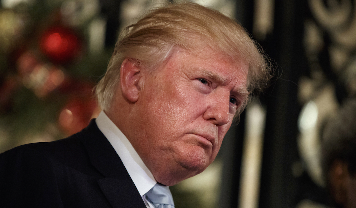 President-elect Donald Trump listens to a question as he speaks to reporters at Mar-a-Lago