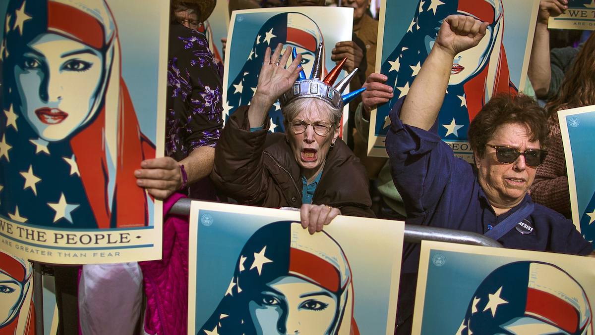  FILE - In this Feb. 19, 2017 file photo, people carry posters during a rally against President Donald Trump's executive order banning travel from seven Muslim-majority nations, in New York's Times Square. (AP Photo/Andres Kudacki, File) 