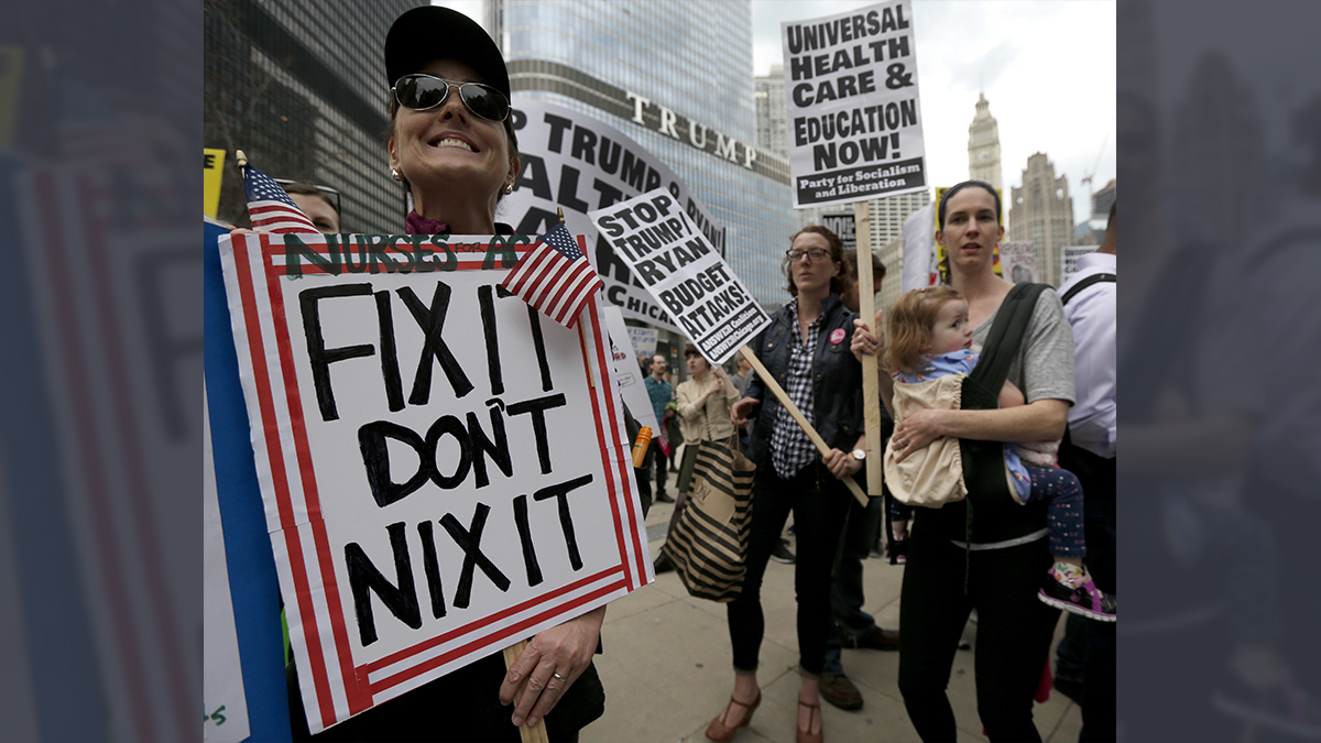  Protesters gather across the Chicago River from Trump Tower to rally against the repeal of the Affordable Care Act Friday, March 24, 2017, in Chicago. Earlier, President Donald Trump and GOP leaders yanked their bill to repeal 