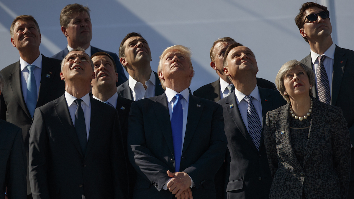  President Donald Trump and NATO leaders watch a flyover during a transfer ceremony at the new NATO headquarters, Thursday, May 25, 2017, in Brussels. (AP Photo/Evan Vucci) 